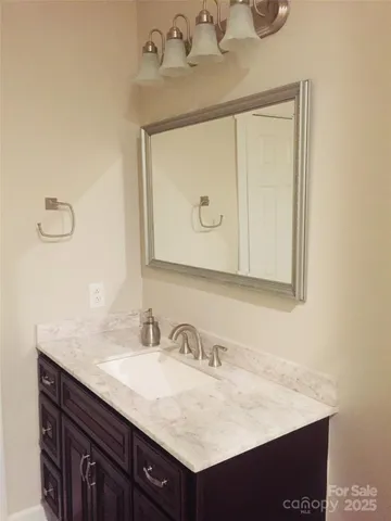 a bathroom with a sink vanity and a mirror