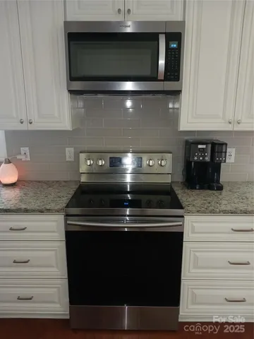 a stove top oven sitting inside of a kitchen