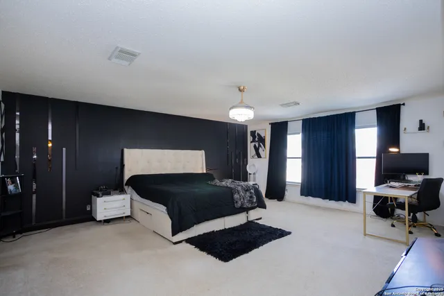 a bedroom with a bed and a chair