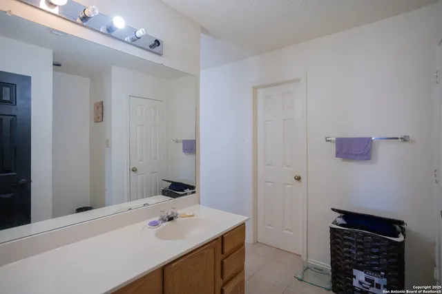 a bathroom with a sink a vanity and a mirror