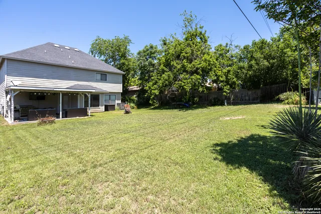 a view of a house with pool and garden