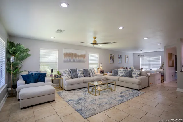 a living room with furniture and a large window