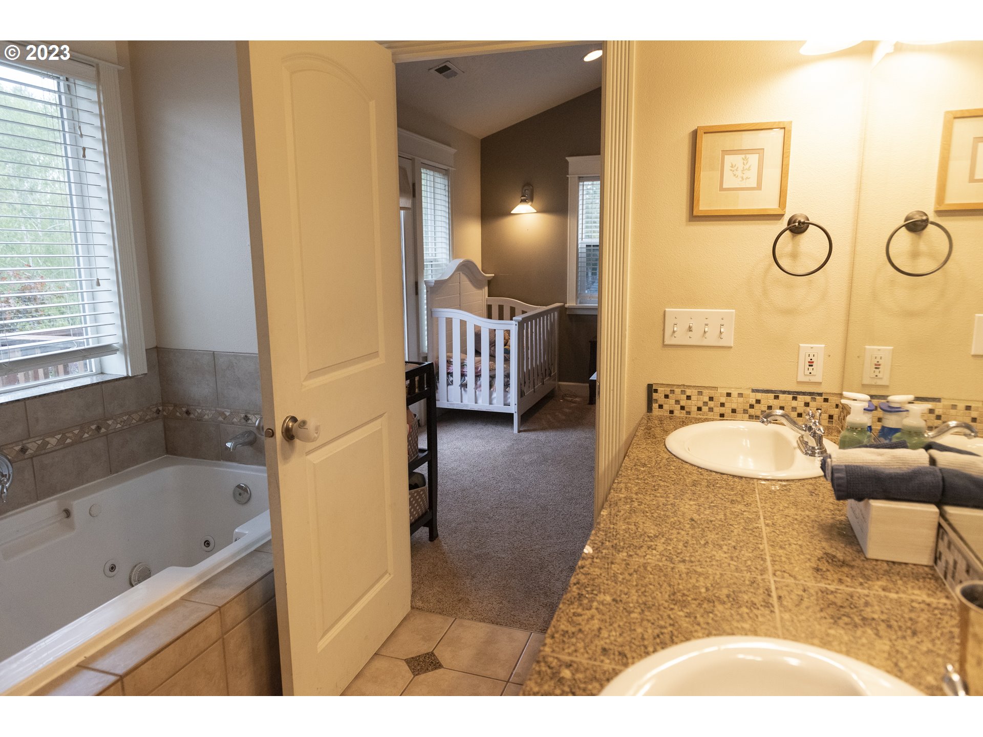 6790 Jacob Lane Springfield, OR 97478 - Photo 21 of 30 a bathroom with a granite countertop tub sink and mirror