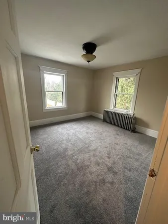 a view of room with a ceiling fan and window