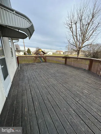 a view of a balcony with wooden floor