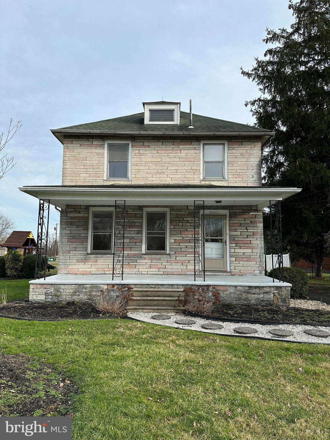 4007 Hulmeville Road Bensalem, PA 19020 - Photo 2 of 16 a front view of a house with a yard
