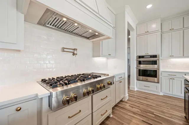 a kitchen with granite countertop a stove and a refrigerator