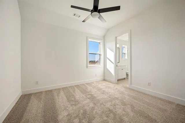 an empty room with closet and windows
