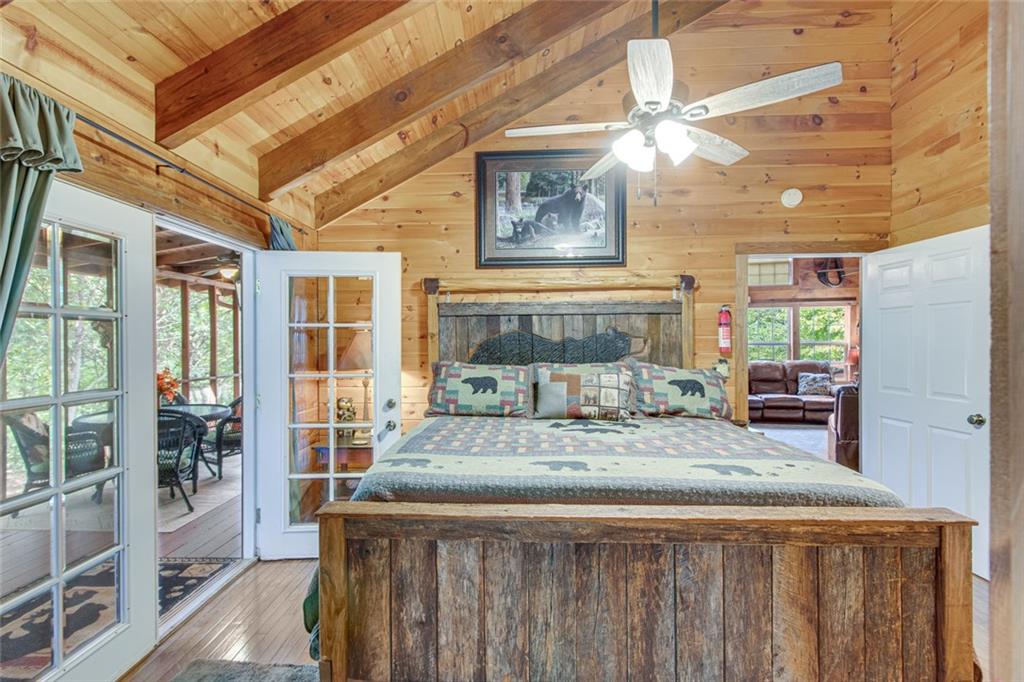 482 Monroe Ridge Road Sautee Nacoochee, GA 30571 - Photo 20 of 25 a room with a bed and glass windows