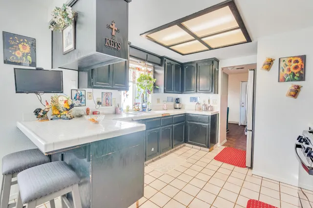 a kitchen with a sink cabinets and window