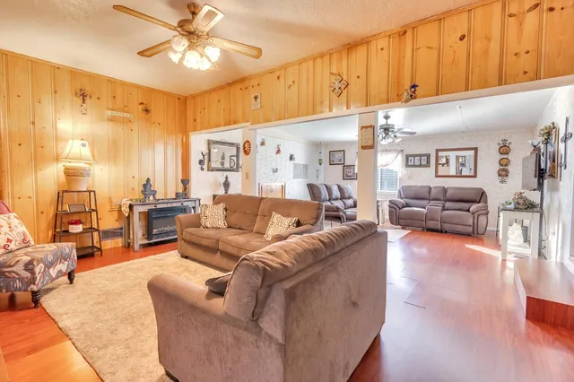 a living room with furniture a couch and chandelier