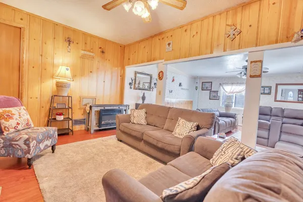 a large bedroom with a bed a couch and dresser