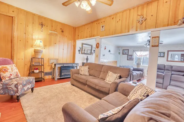 a large bedroom with a bed a couch and dresser