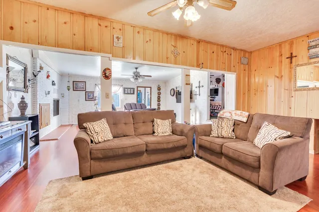 a living room with furniture a refrigerator and a window
