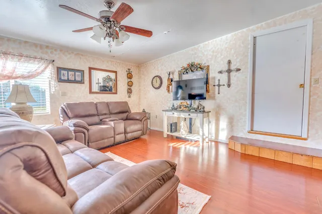 a living room with furniture and wooden floor