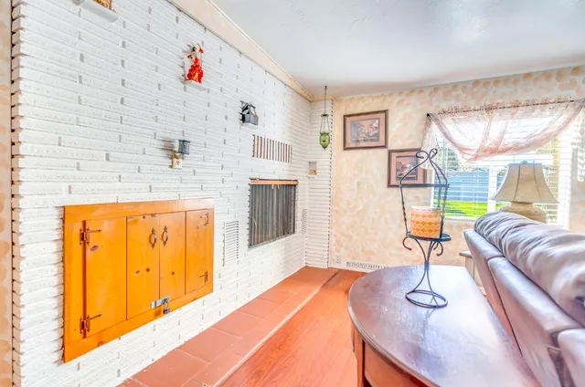 a living room with stainless steel appliances furniture and a table