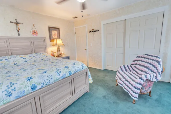 a bedroom with a bed and dresser