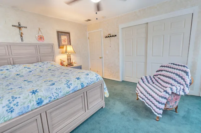 a bedroom with a bed and dresser