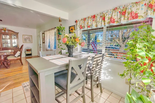 a view of a dining room with furniture a chandelier and wooden floor