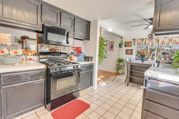 a kitchen with stainless steel appliances granite countertop a stove and a sink