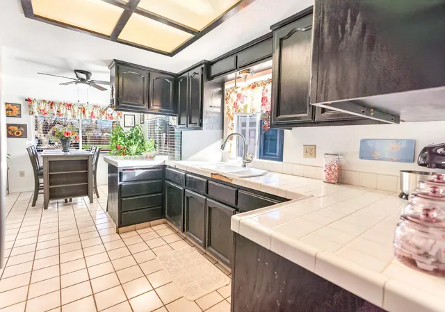 a kitchen with stainless steel appliances kitchen island granite countertop a sink and cabinets