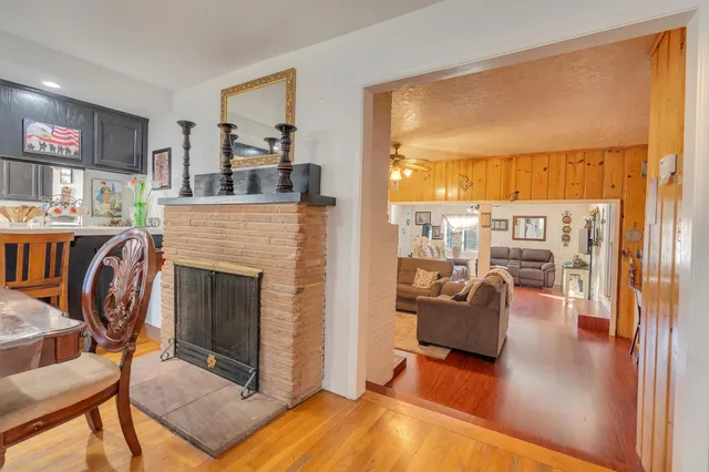 a living room with furniture a fireplace and a large window