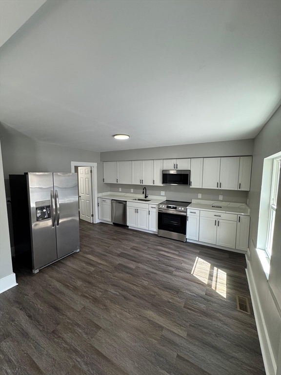 32 Main Street Monson, MA 01057 - Photo 5 of 42 a large kitchen with a white stove top oven and refrigerator