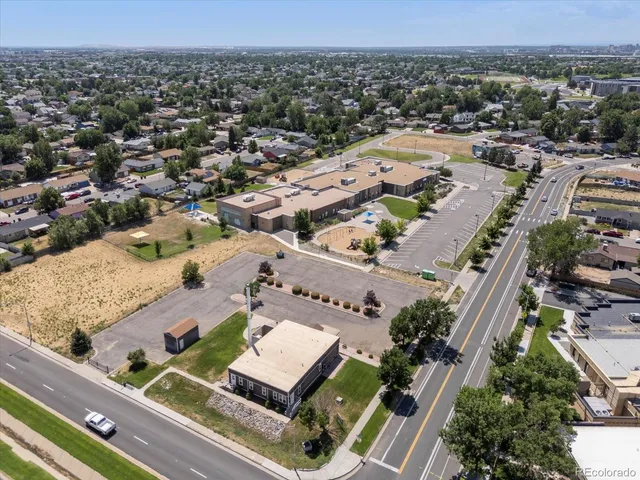 an aerial view of town with residential buildings and green space