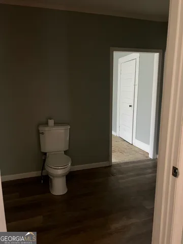a white toilet sitting next to a bathroom sink