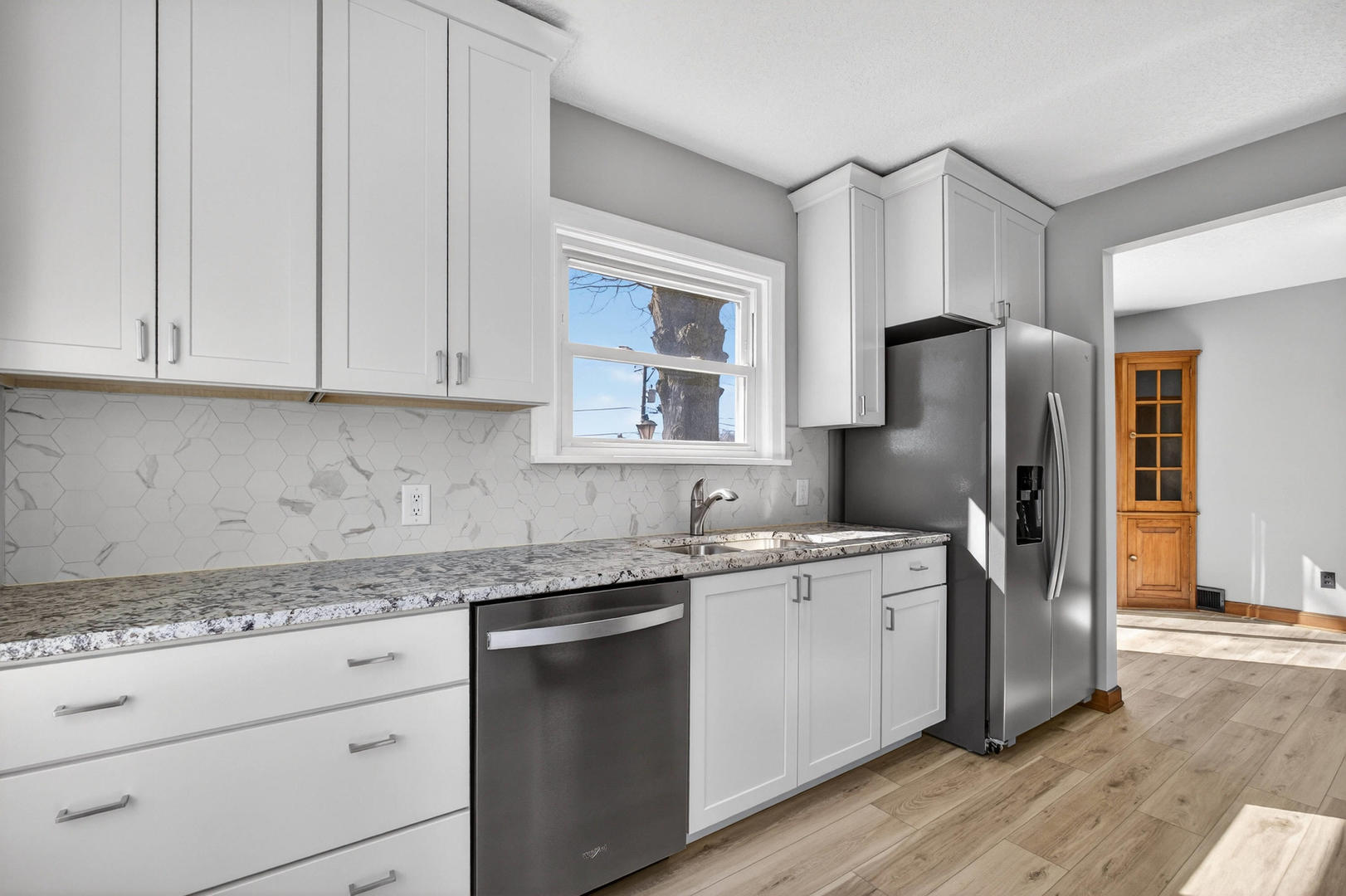 317 West Le Claire Road Eldridge, IA 52748 - Photo 11 of 43 a kitchen with a refrigerator sink and cabinets