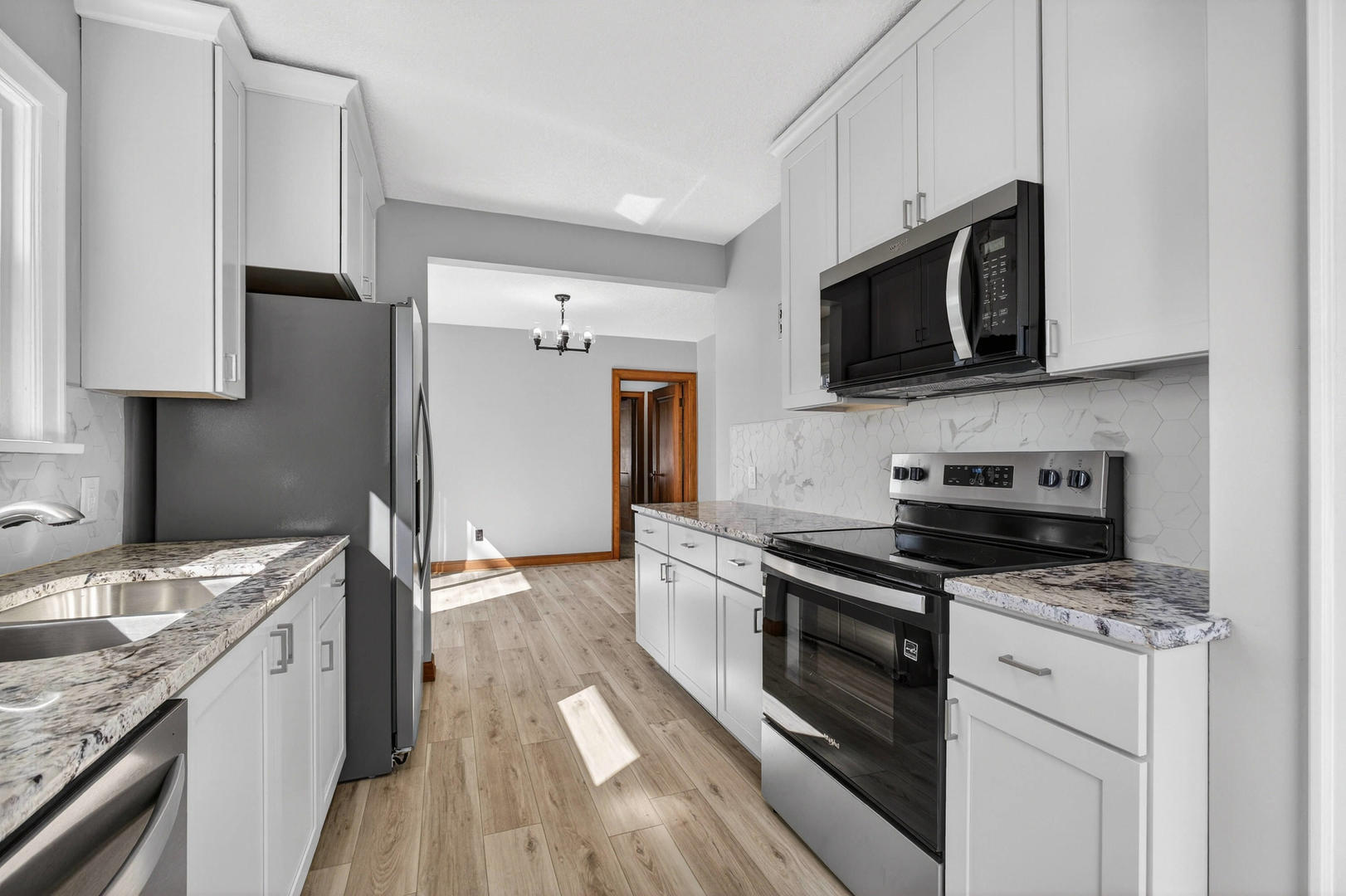 317 West Le Claire Road Eldridge, IA 52748 - Photo 12 of 43 a kitchen with stainless steel appliances a stove microwave and a refrigerator