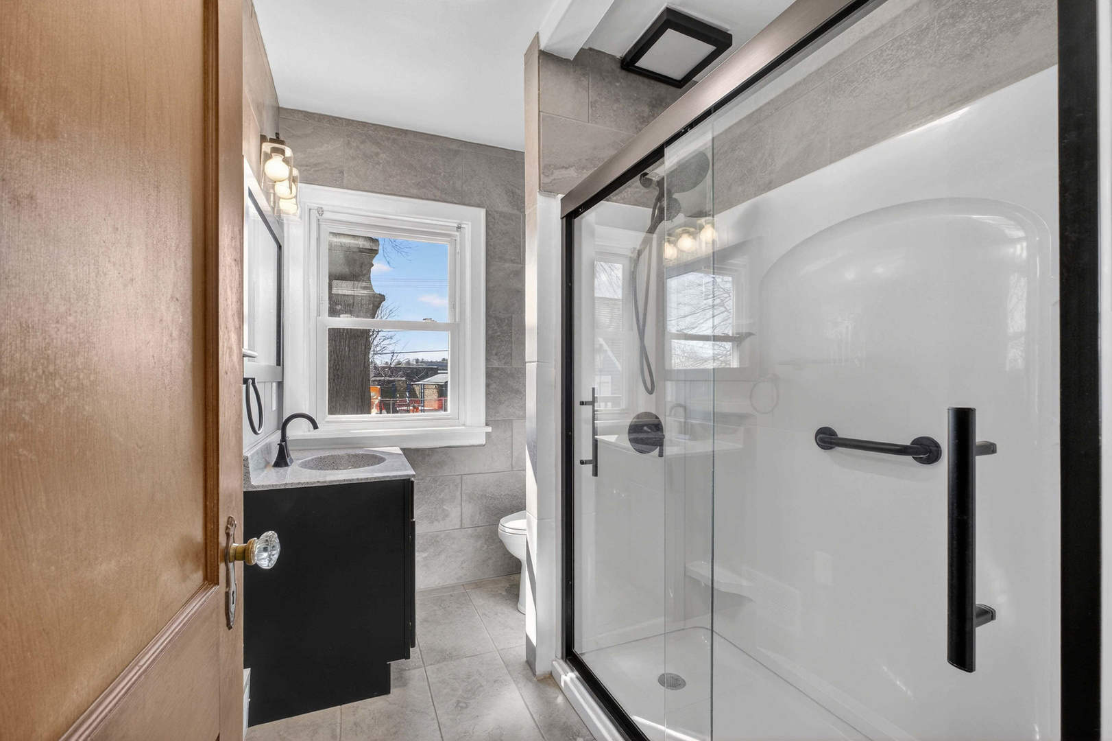 317 West Le Claire Road Eldridge, IA 52748 - Photo 13 of 43 a bathroom with a granite countertop sink mirror and shower