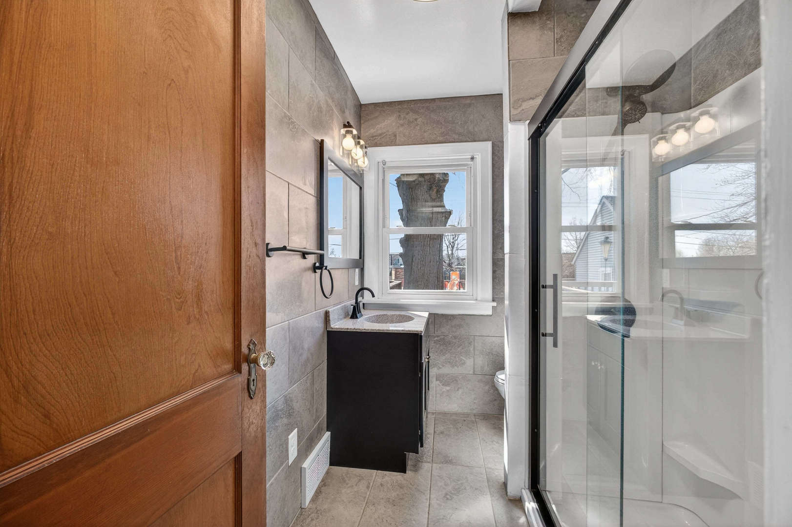 317 West Le Claire Road Eldridge, IA 52748 - Photo 14 of 43 a bathroom with a sink and mirror with bathtub