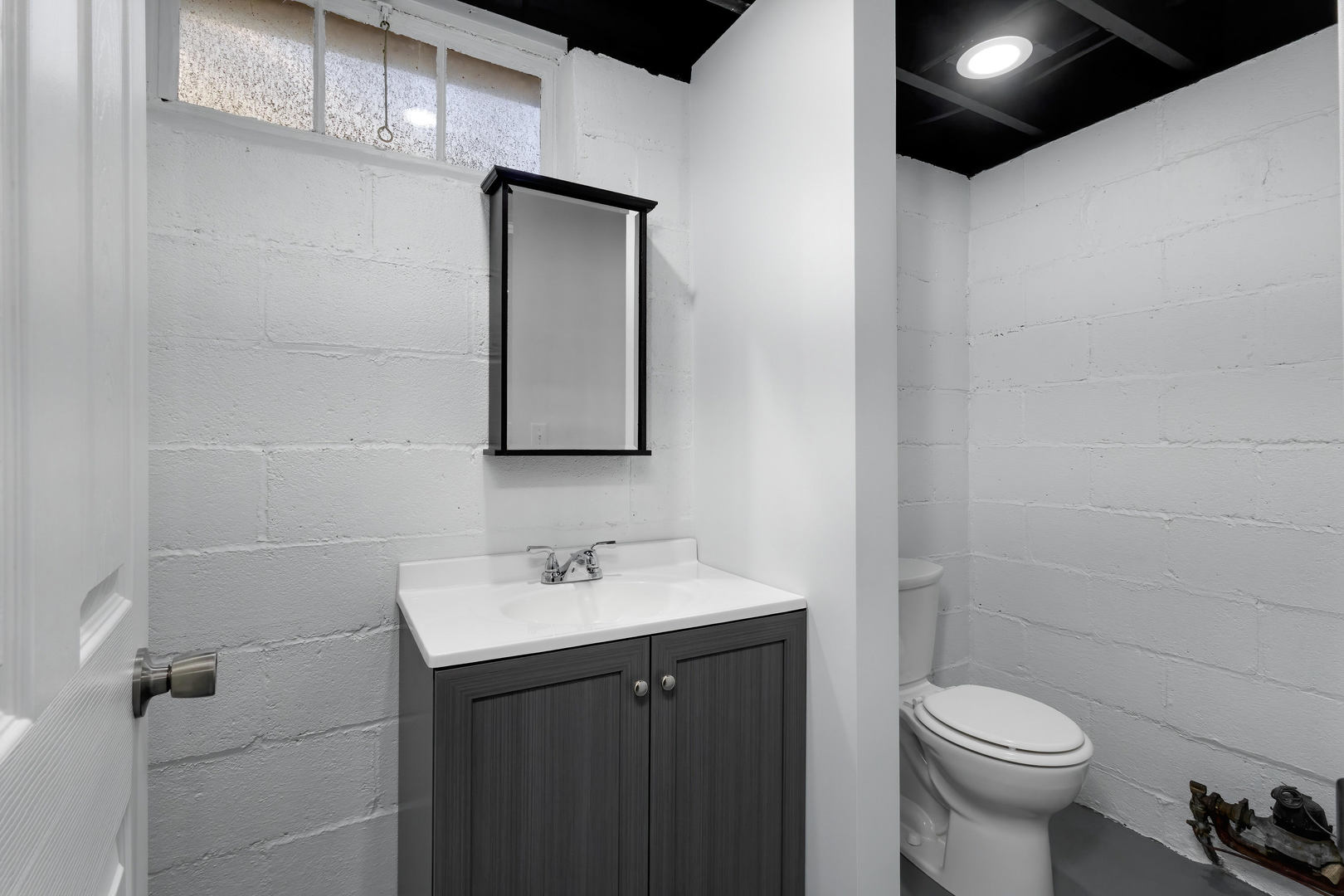 317 West Le Claire Road Eldridge, IA 52748 - Photo 31 of 43 a bathroom with a toilet sink and mirror