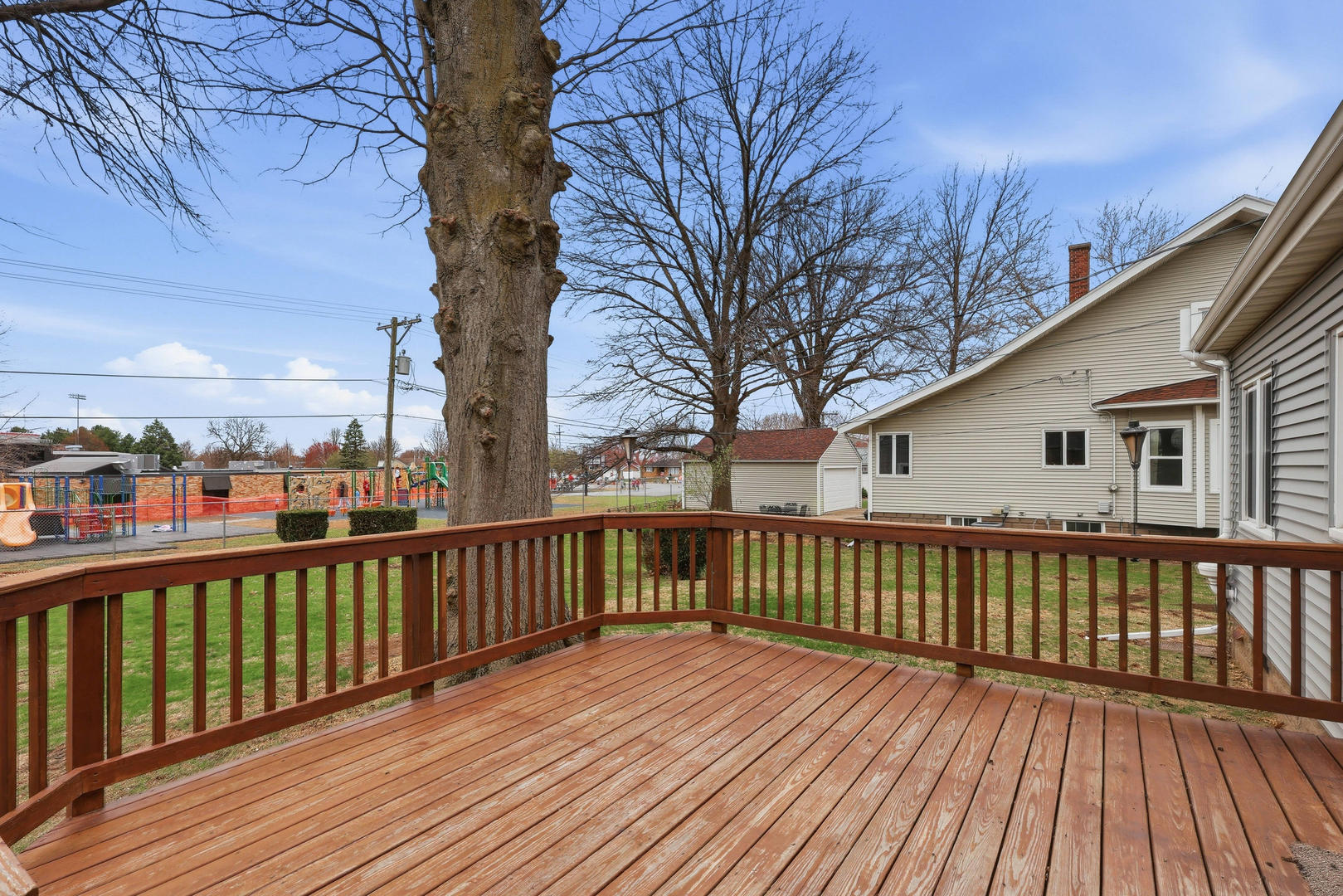 317 West Le Claire Road Eldridge, IA 52748 - Photo 38 of 43 a view of a wooden deck with large trees