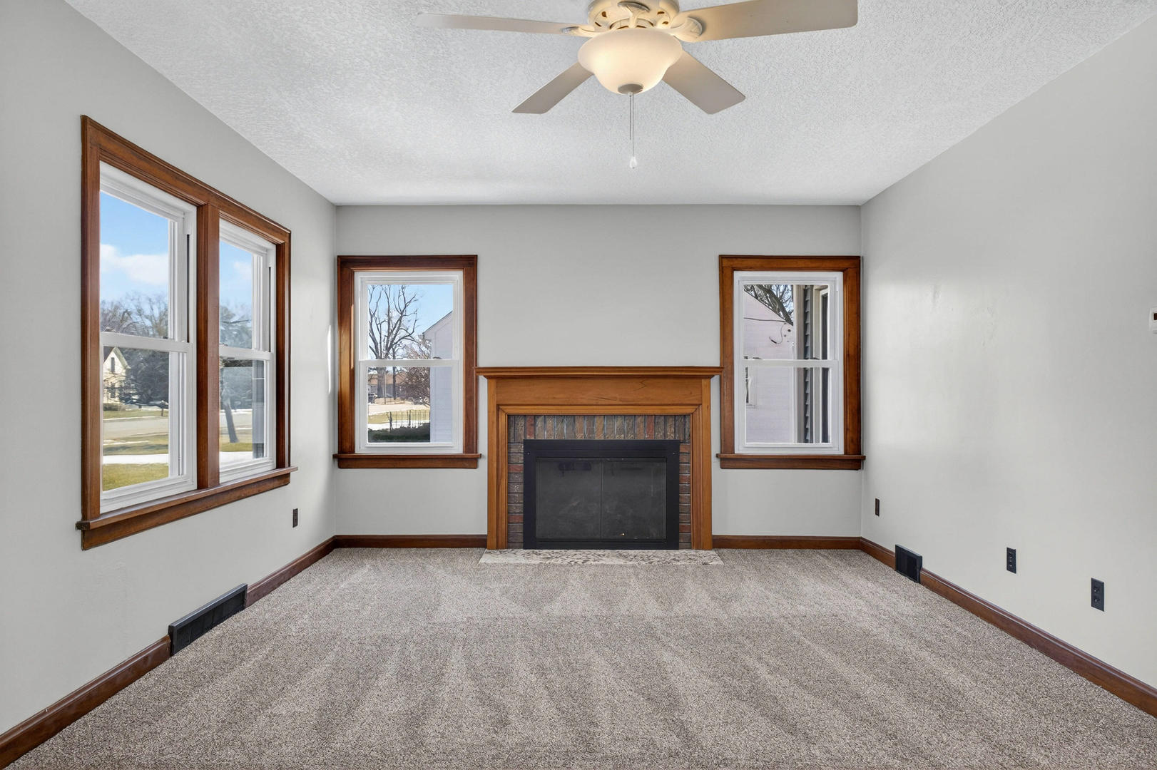 317 West Le Claire Road Eldridge, IA 52748 - Photo 4 of 43 a view of an empty room with a window and fireplace