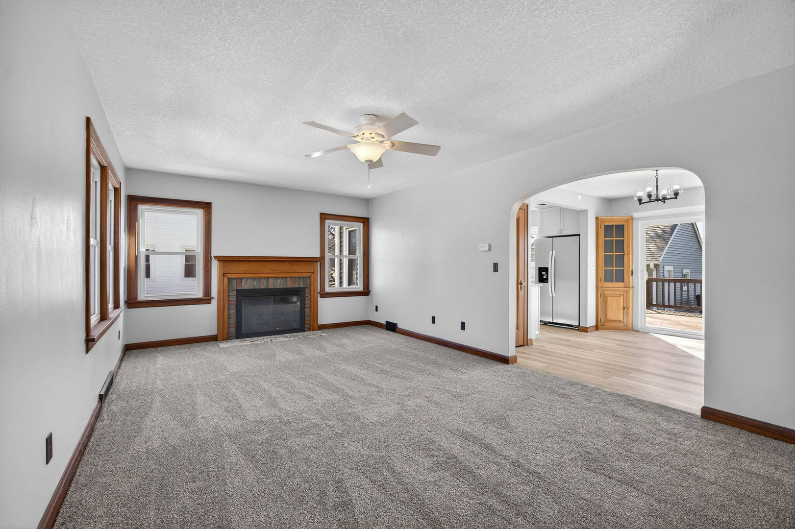 317 West Le Claire Road Eldridge, IA 52748 - Photo 5 of 43 an empty room with fireplace and windows