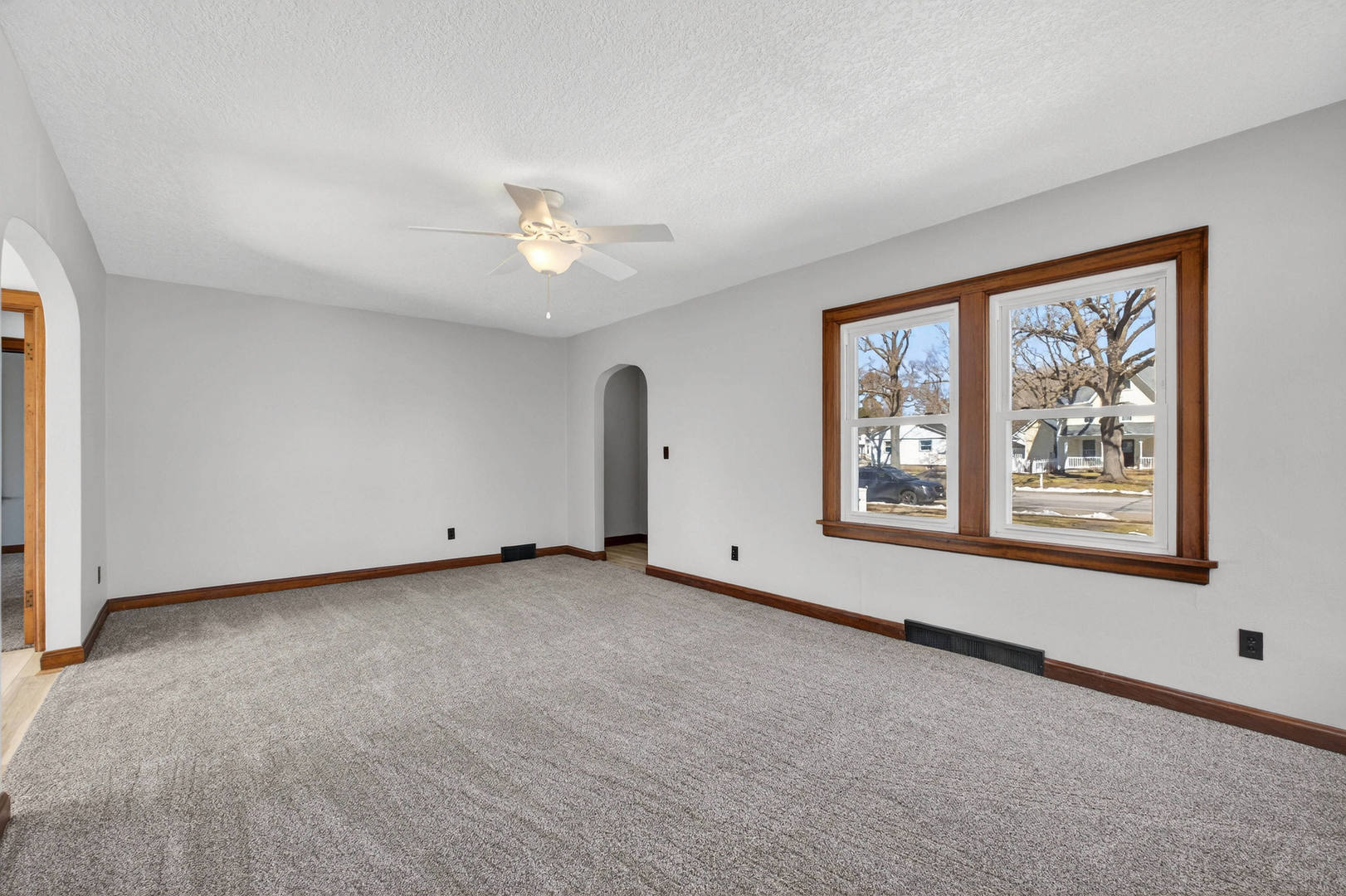 317 West Le Claire Road Eldridge, IA 52748 - Photo 6 of 43 a view of a big room with windows and chandelier fan