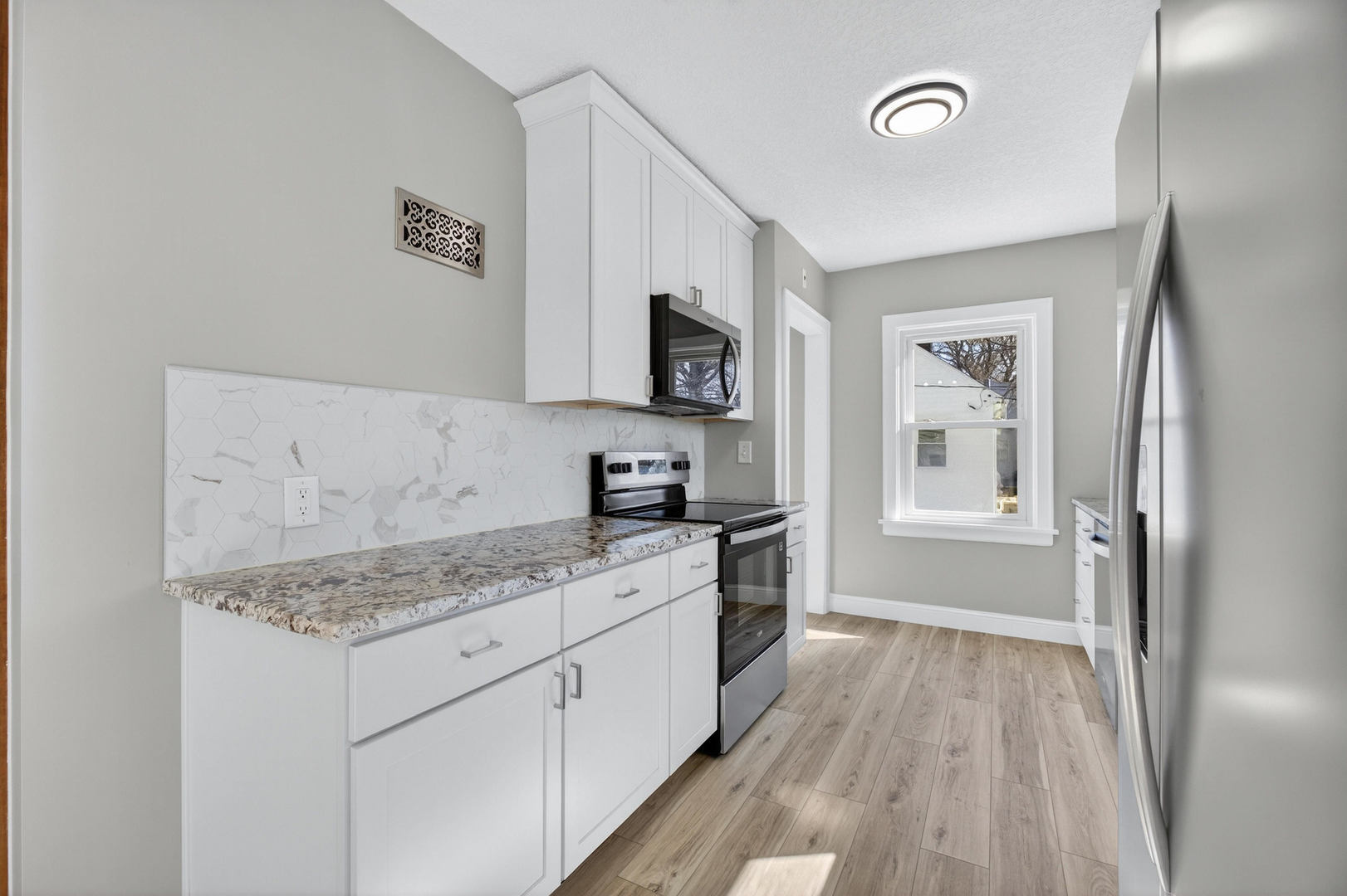 317 West Le Claire Road Eldridge, IA 52748 - Photo 10 of 43 a kitchen with a sink stove and refrigerator