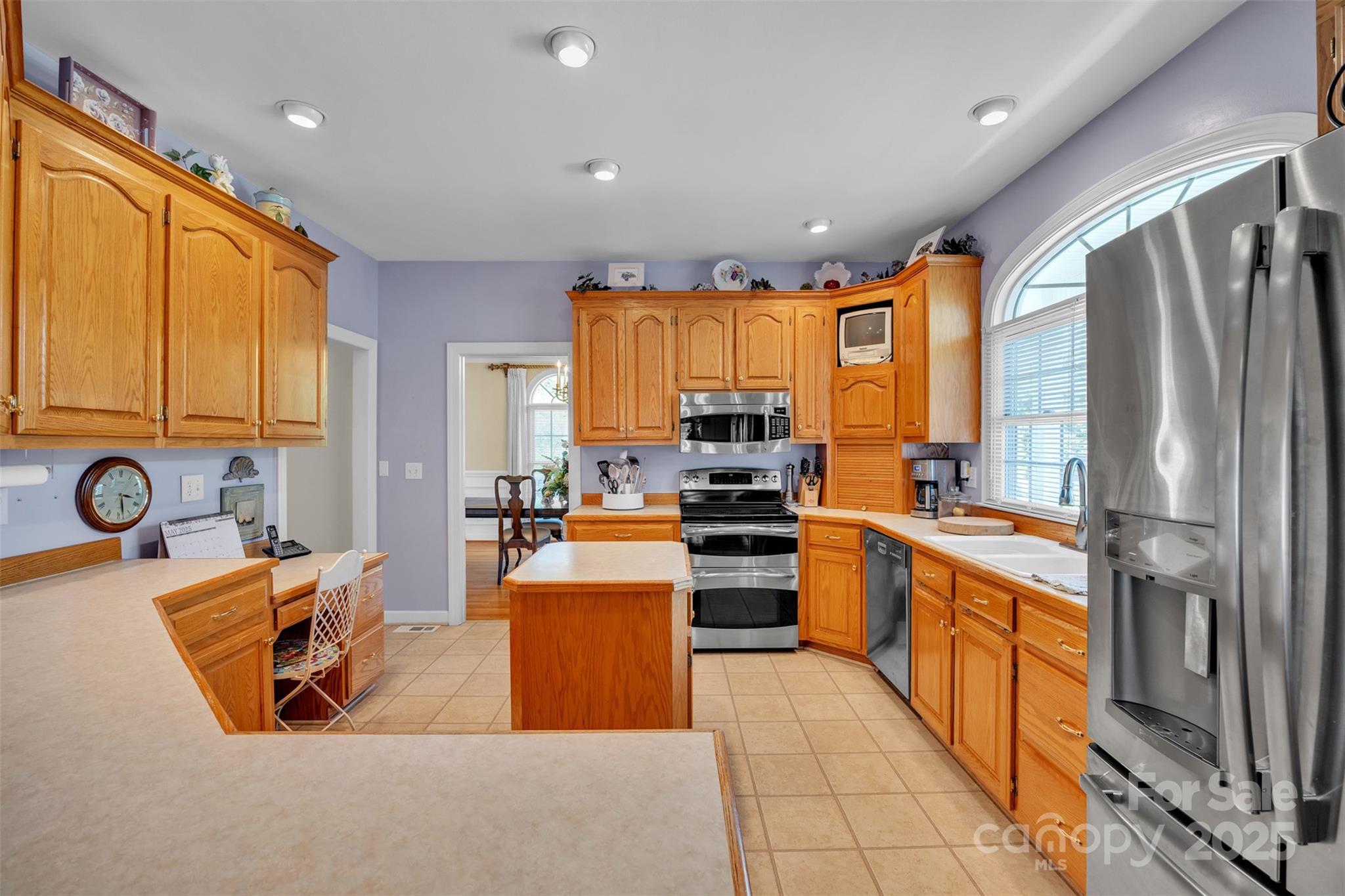 129 Renaissance Place Statesville, NC 28625 - Photo 6 of 43 a kitchen with stainless steel appliances granite countertop a refrigerator a stove top oven a sink dishwasher and wooden cabinets with large window