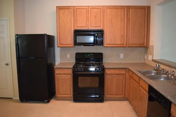 a kitchen with a refrigerator and a sink
