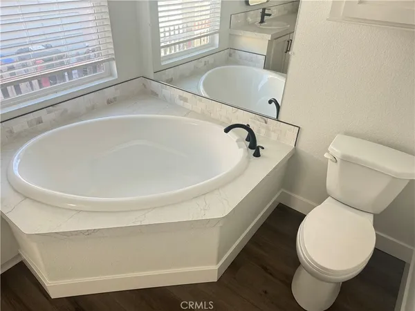 a white toilet sitting next to a bathroom sink