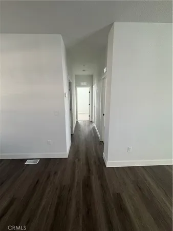 wooden floor in a hall with an empty room