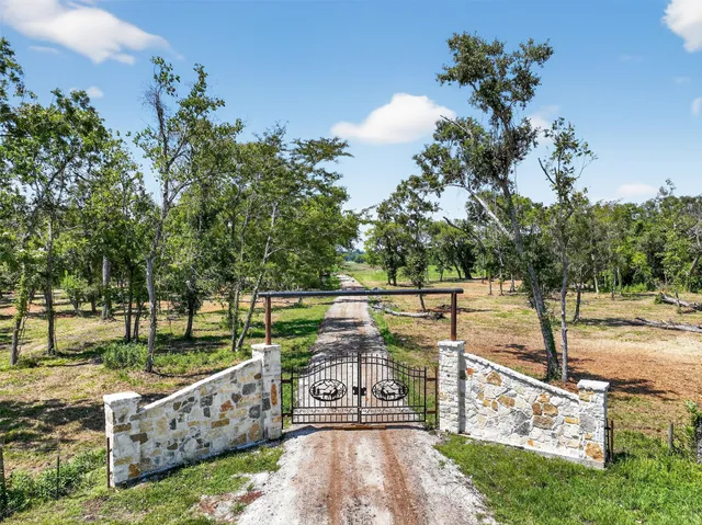 a view of a pathway with a wrought fence