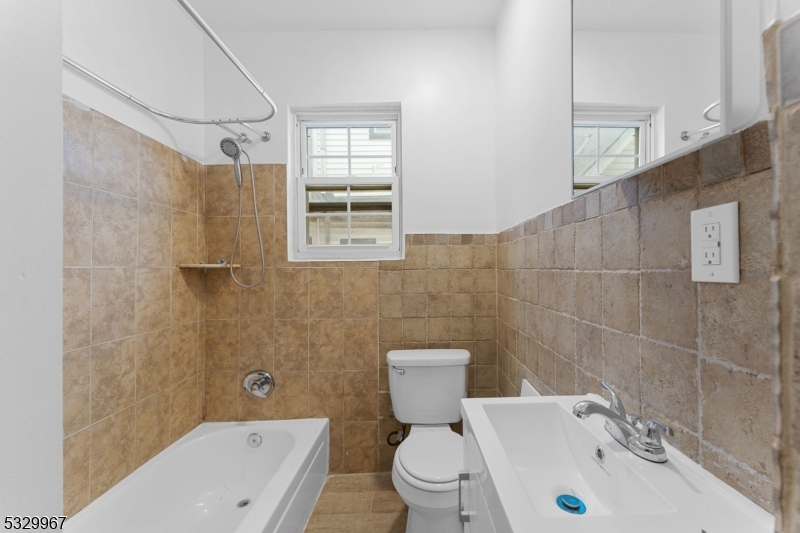 18 Lowden Street Elizabeth, NJ 07208 - Photo 12 of 17 a bathroom with a sink toilet and shower