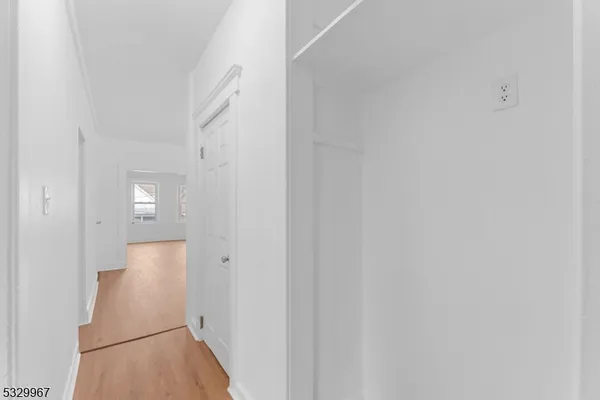 a view of hallway with wooden floor