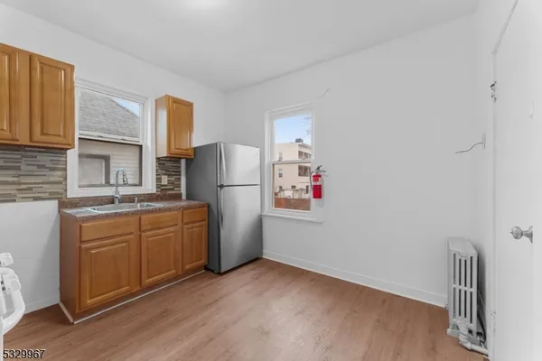 a kitchen with refrigerator a microwave and cabinets