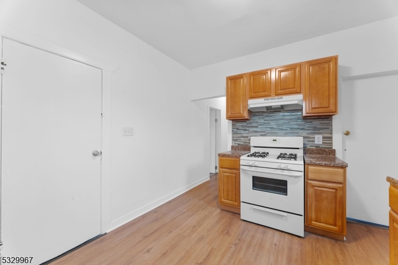 18 Lowden Street Elizabeth, NJ 07208 - Photo 17 of 17 a kitchen with a stove and a white wooden cabinets