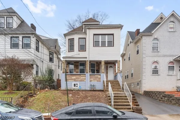 a front view of a house with stairs