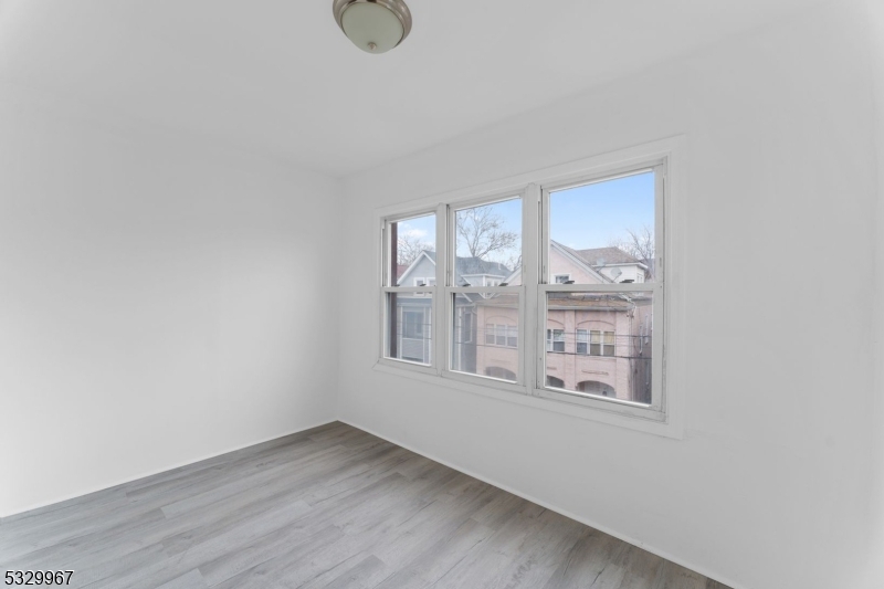 18 Lowden Street Elizabeth, NJ 07208 - Photo 7 of 17 a view of an empty room with a window
